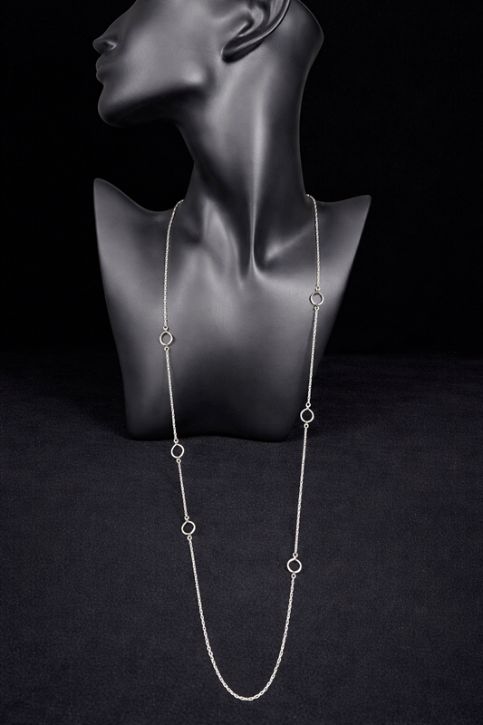 This long sterling silver necklace is designed with intermittent geometric links along the length of the chain. Two of those large links feature a small diamond for a touch of flash in the light. At 34 inches, this can be wrapped twice for a layered look, or it can be worn long. Made by Silpada.