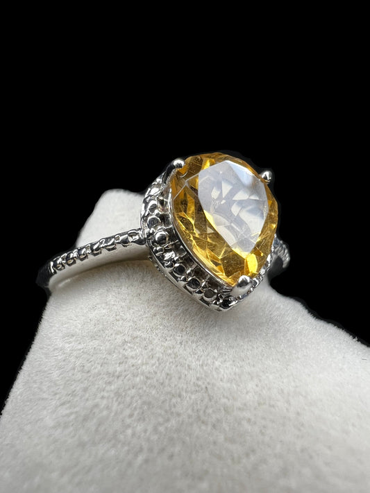 This exquisite ring features a pear-shaped citrine set in polished sterling silver, combining timeless elegance with vibrant color.