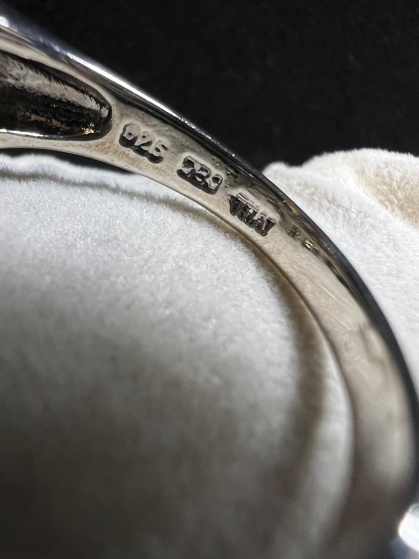 This sterling silver ring features over two dozen meticulously set blue spinel and green tourmaline stones, creating a vibrant interplay of color and brilliance.