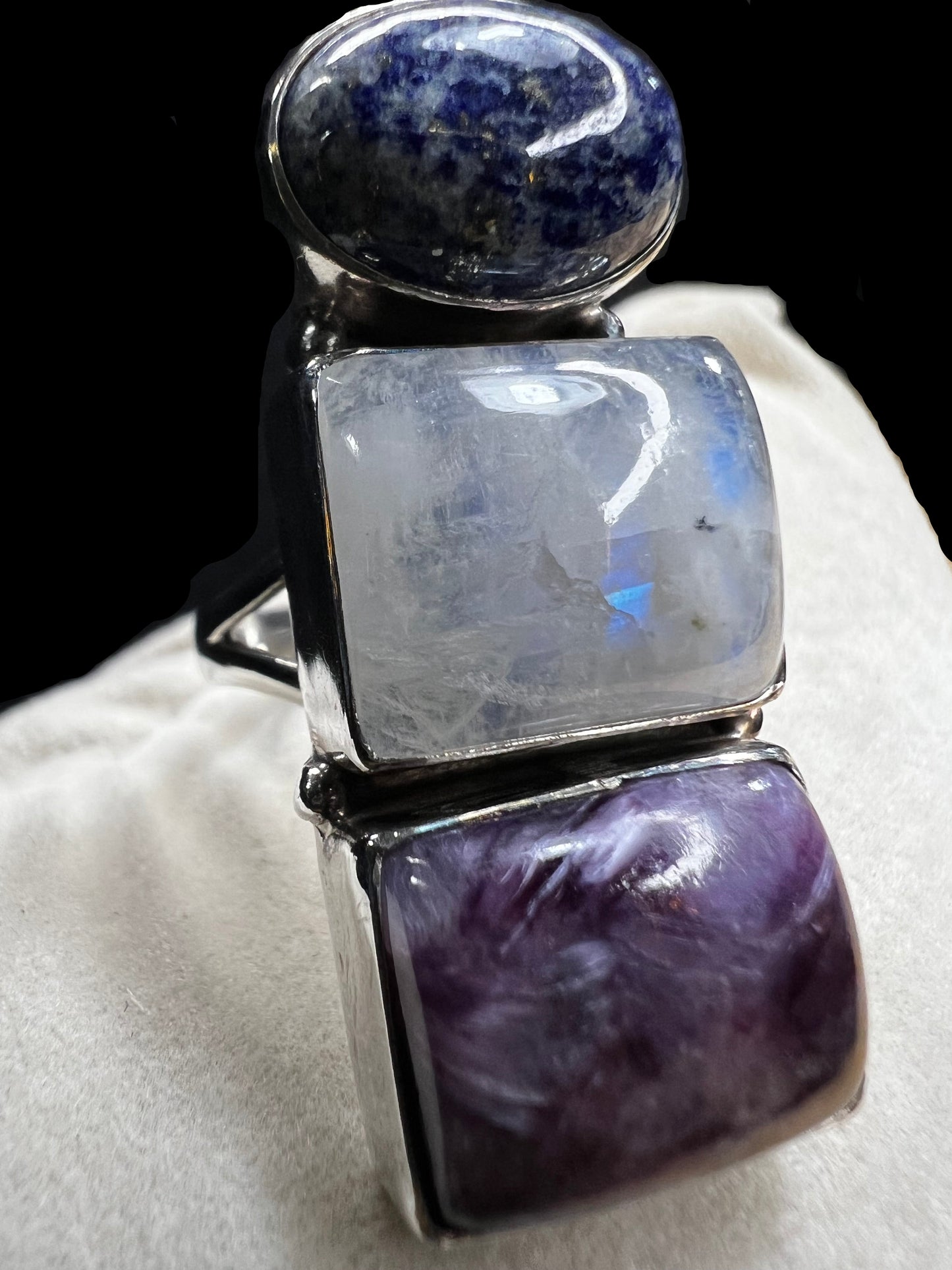 Crafted from sterling silver and set with three natural stones, this ring will certainly make a statement. There is a natural inclusion on the moonstone.