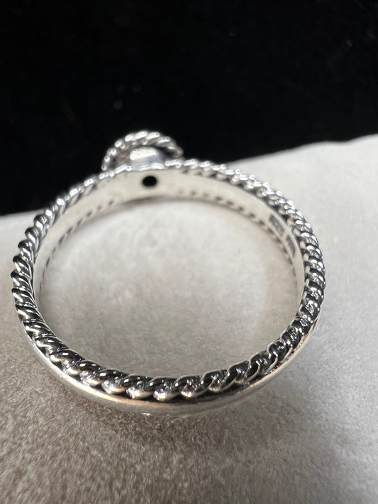 This sterling silver ring is thoughtfully designed with detailed craftsmanship and features a beautiful green amethyst at its center.