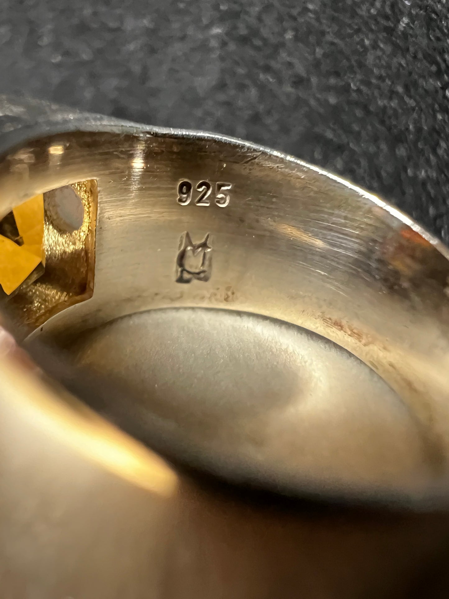 This expertly crafted vintage ring showcases a large, vibrant citrine centerpiece flanked by two luminous opals, all set in high-quality sterling silver. The hallmark of the maker (CM) is stamped on the inside.