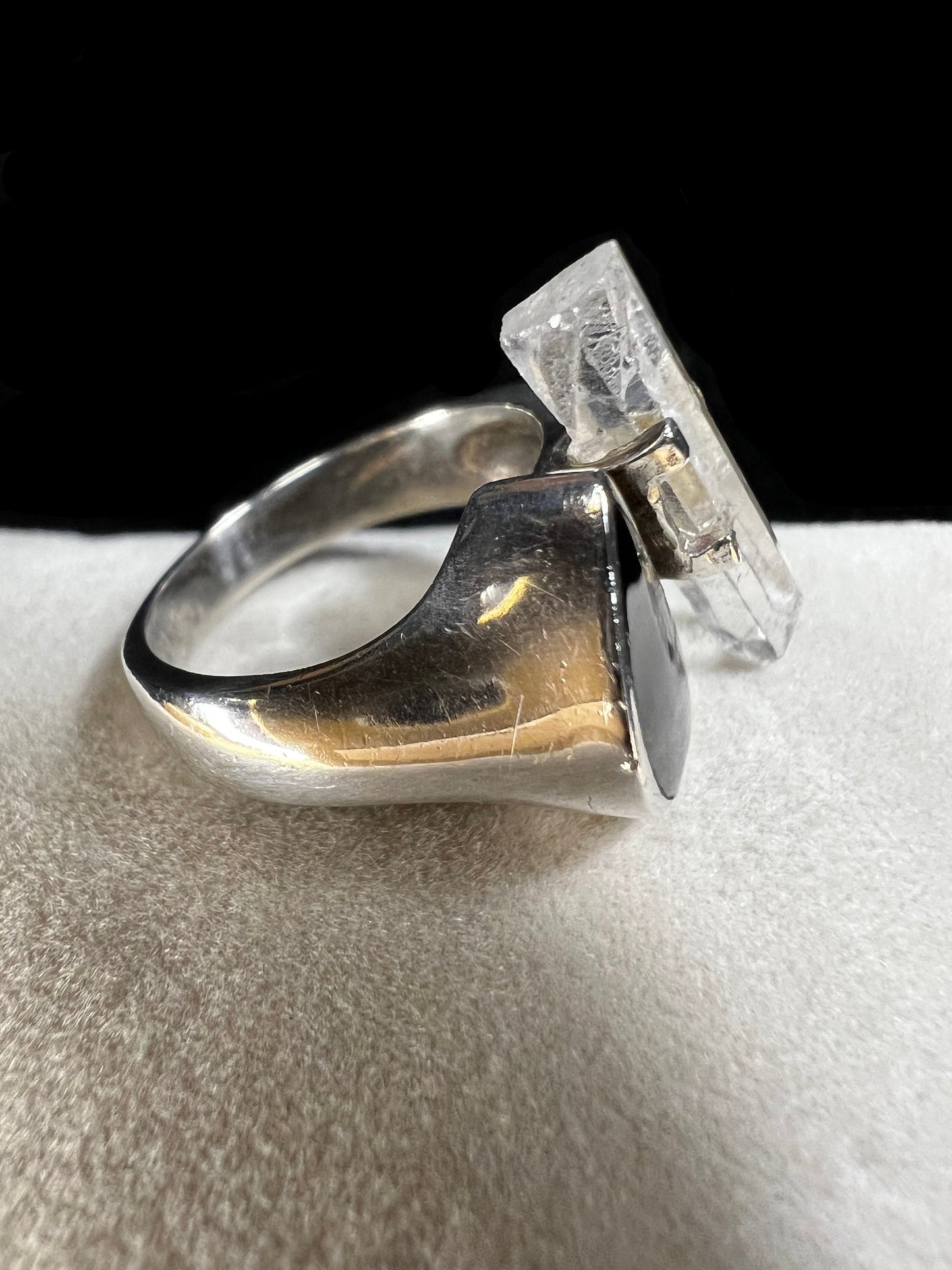 This sterling silver ring features a striking combination of black enamel and a natural crystal specimen. Its moderate size ensures it stands out without overwhelming, making it an ideal complement to any outfit.