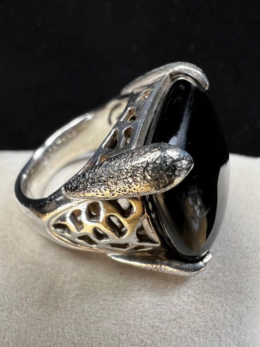 This sterling silver ring showcases an onyx stone. Its exquisite design balances elegance and comfort, ensuring a sophisticated accessory that feels as good as it looks for everyday wear.