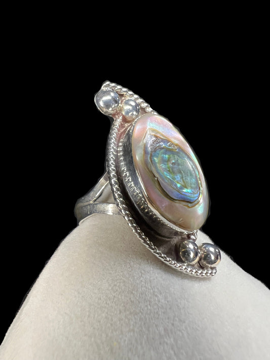 This vintage Taxco ring is a great find. The ring is crafted from sterling silver and showcases a beautiful piece of abalone, which is nestled in a bed of rope silver and small silver rounds that look like little pearls.