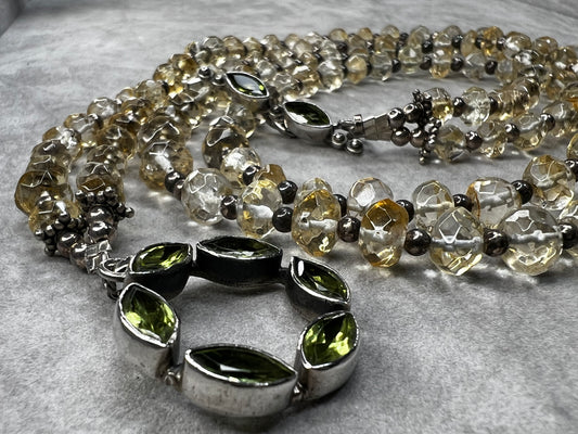 This necklace combines sterling silver with finely faceted translucent citrine beads, accented by a distinctive peridot toggle clasp. Its unique design offers a timeless elegance that complements any outfit.