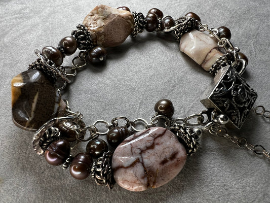 This bracelet combines quality craftsmanship with elegant design. Made from sterling silver and natural stone, it offers graceful movement on your wrist.