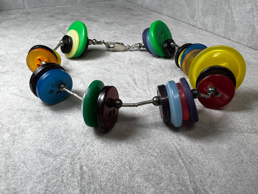Made with sterling silver beads & clasp, this bracelet features colorful buttons for something different and fun.
