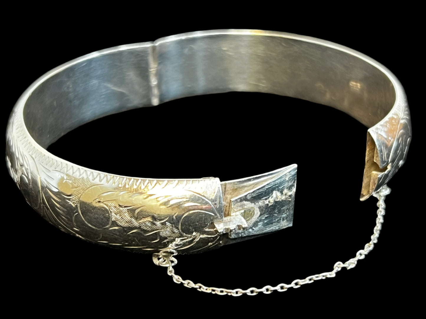 If you're searching for an authentic vintage look, this bracelet is it. Crafted from fine sterling silver, this bracelet has been hand-etched to create a unique design that stretches around the entire bracelet.
