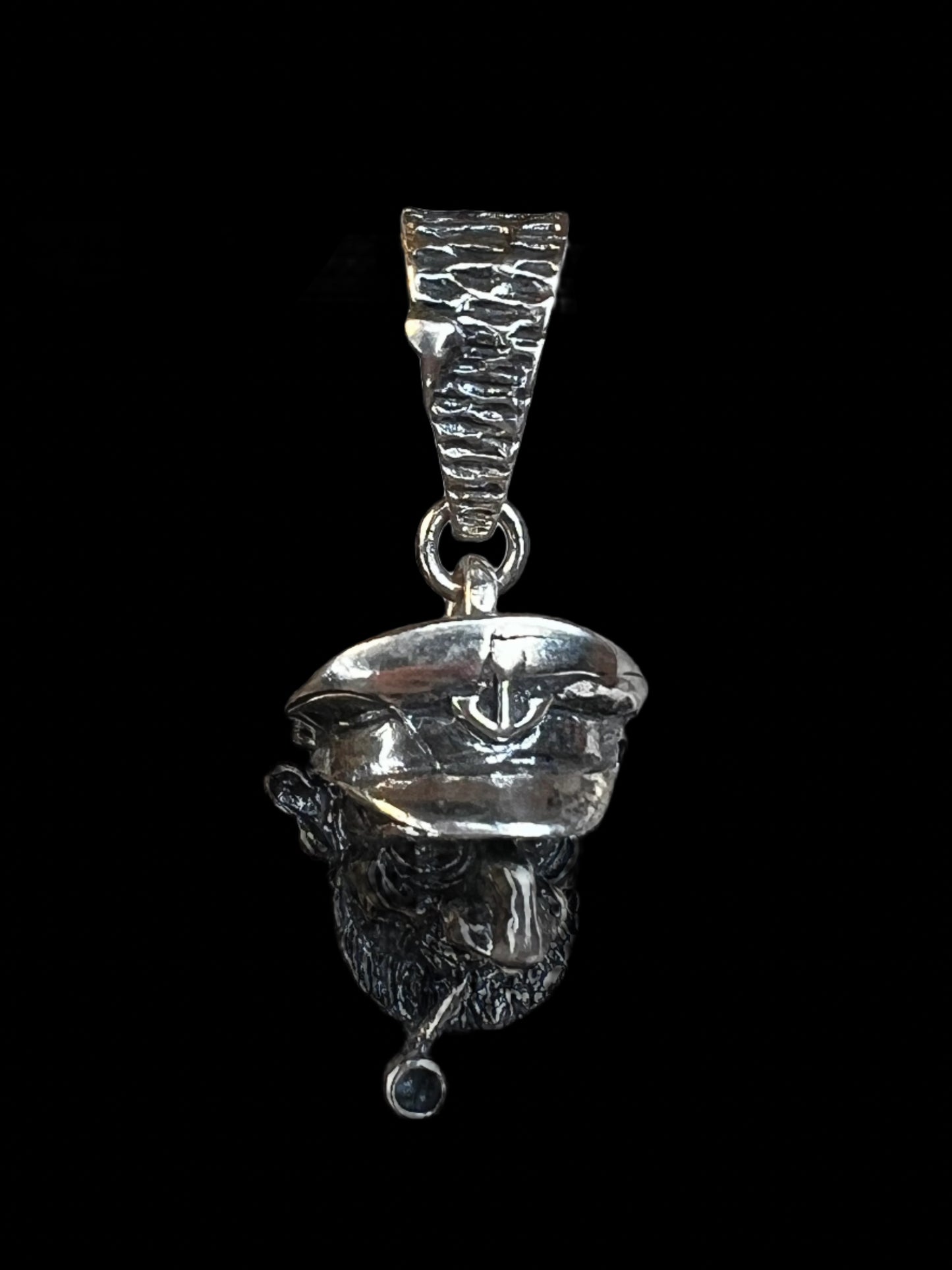 This vintage pendant is intricately crafted from sterling silver. It is jointed, which allows for a slight movement of the hat.