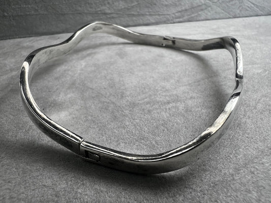 This vintage Taxco sterling silver bracelet features a distinctive wavy design and is marked TM-37, showcasing authentic craftsmanship from Mexico. Its timeless style makes it a versatile accessory for everyday wear or special occasions.