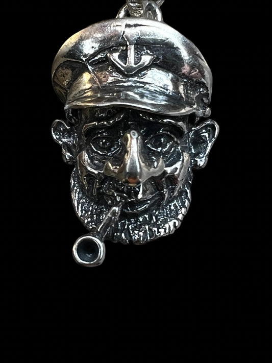 This vintage pendant is intricately crafted from sterling silver. It is jointed, which allows for a slight movement of the hat.