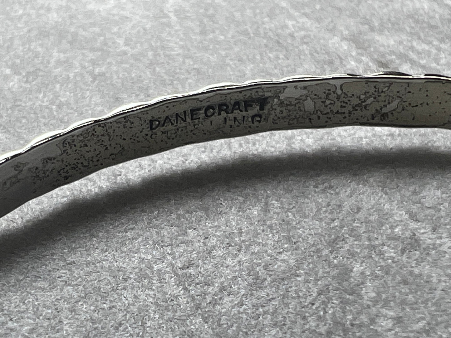 This vintage Danecraft sterling silver bracelet offers timeless elegance with its simple yet detailed design. Crafted with care, it provides a classic accessory that complements any outfit while ensuring durability and comfort for everyday wear.