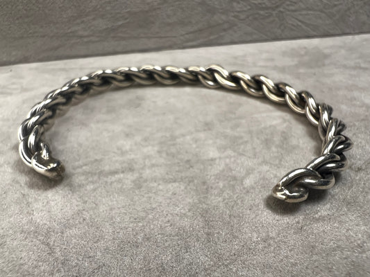 This bracelet is made of braided solid sterling silver wire and shaped to sit very nicely on your wrist.