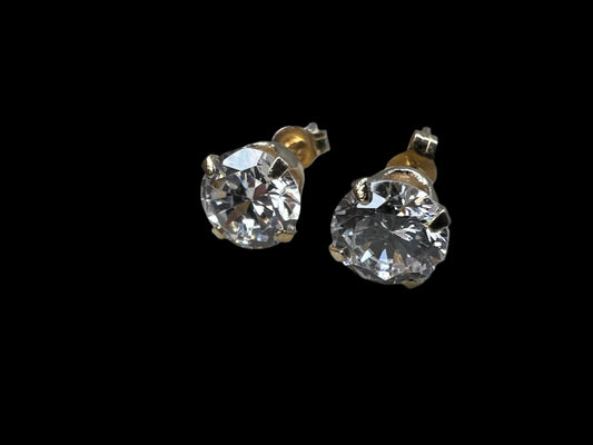 Add a touch of diamond-like sparkle to your outfit without the cost. These 14 karat gold stud earrings are adorned with cubic zirconia stones.