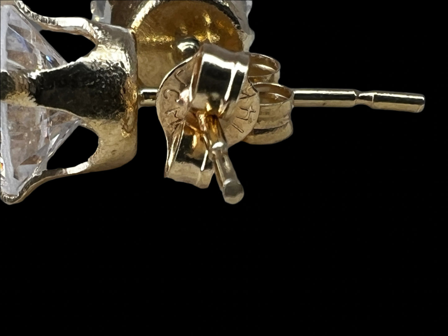 Add a touch of diamond-like sparkle to your outfit without the cost. These 14 karat gold stud earrings are adorned with cubic zirconia stones.