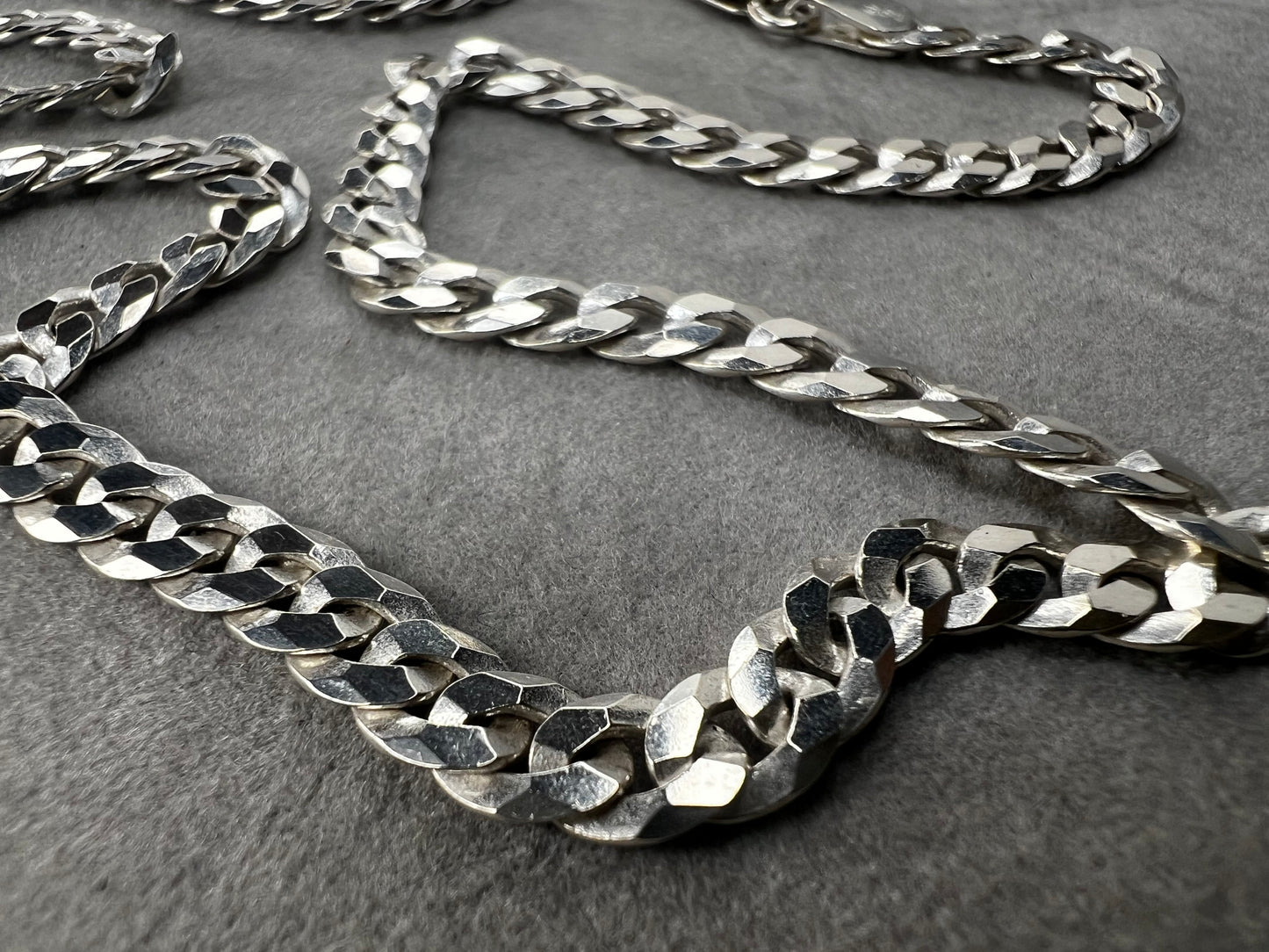 This 24" sterling silver Cuban link chain features a high polish finish that adds a sleek, timeless shine. Its sturdy yet elegant design makes it a versatile accessory, perfect for everyday wear or pairing with your favorite pendant.