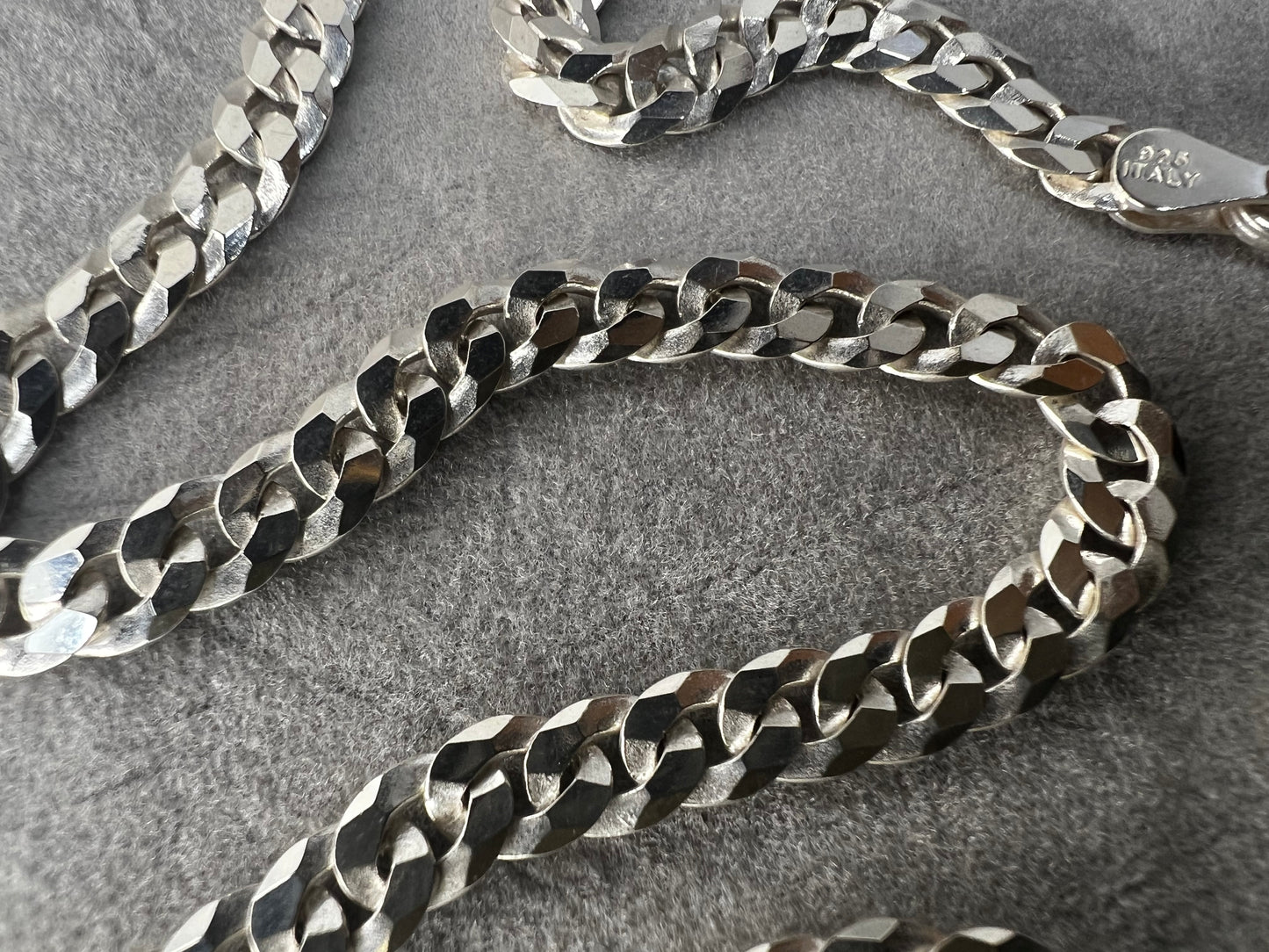 This 24" sterling silver Cuban link chain features a high polish finish that adds a sleek, timeless shine. Its sturdy yet elegant design makes it a versatile accessory, perfect for everyday wear or pairing with your favorite pendant.