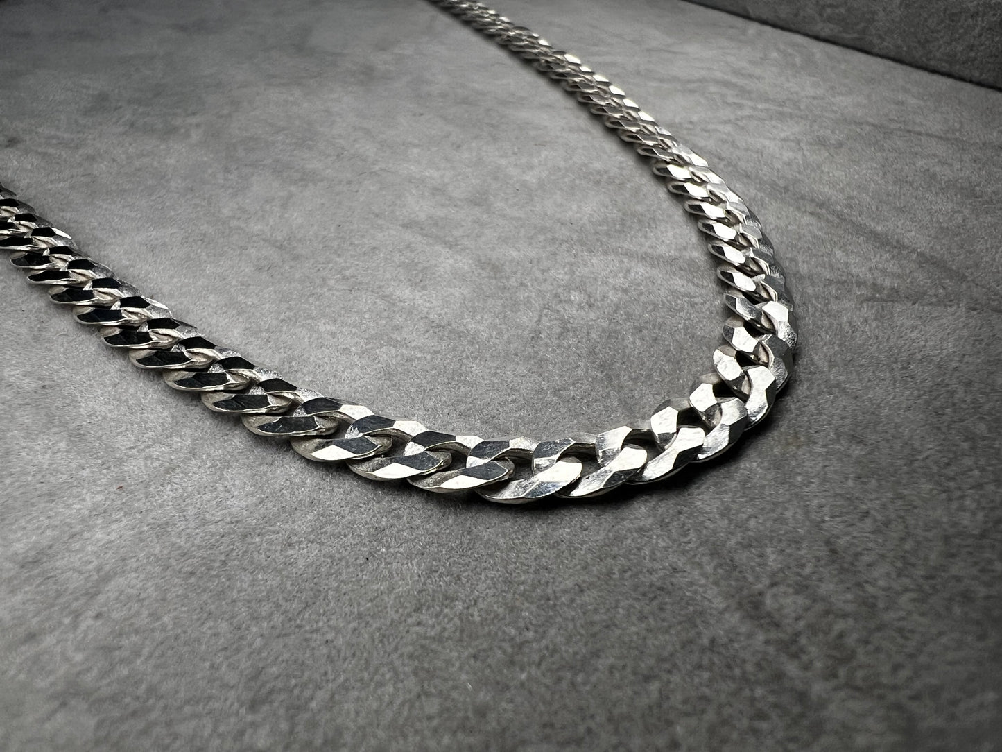 This 24" sterling silver Cuban link chain features a high polish finish that adds a sleek, timeless shine. Its sturdy yet elegant design makes it a versatile accessory, perfect for everyday wear or pairing with your favorite pendant.