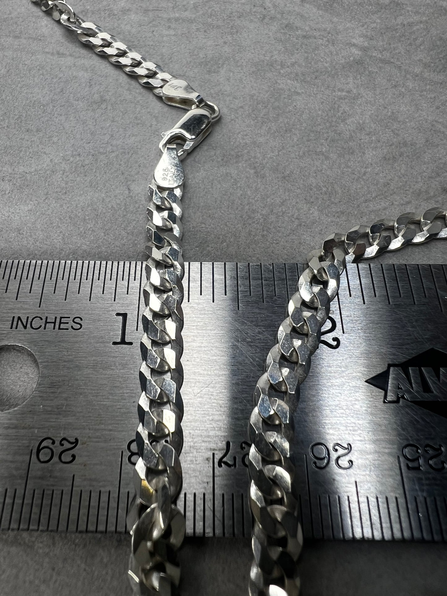 This 24" sterling silver Cuban link chain features a high polish finish that adds a sleek, timeless shine. Its sturdy yet elegant design makes it a versatile accessory, perfect for everyday wear or pairing with your favorite pendant.