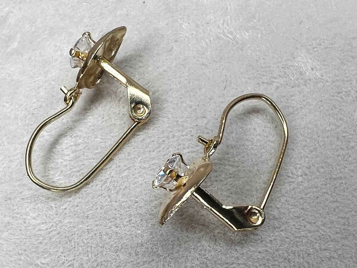 These beautiful 14 karat gold earrings are set with cubic zirconia stones, which provide the sparkling allure of diamonds without the cost.