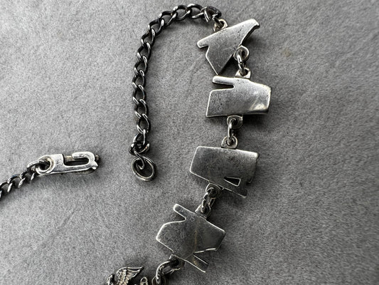 This sterling silver "Forget Me Not" bracelet from the World War II era carries a heartfelt story. Given by a U.S. Navy sailor to a loved one before deployment, it served as a meaningful reminder of their bond during difficult times apart.