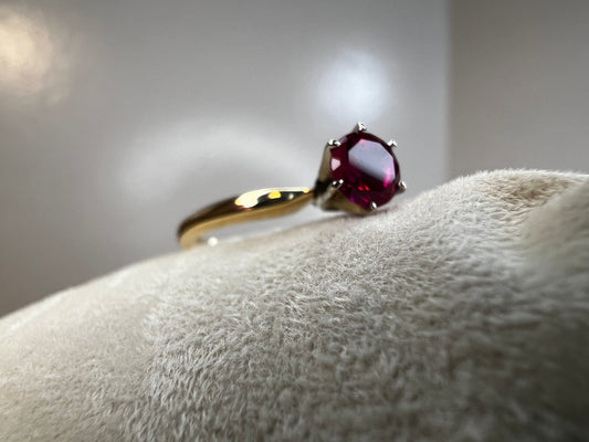 Elevate your style with our 14 karat gold ring. Featuring a beautiful ruby, this piece will add a touch of luxury to any outfit.