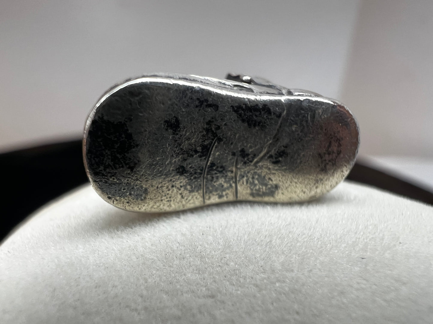 Indulge in some cuteness with this vintage sterling silver charm. Expertly crafted as a miniature baby shoe, this piece is perfect for a new parent or anyone who enjoys a touch of nostalgia.