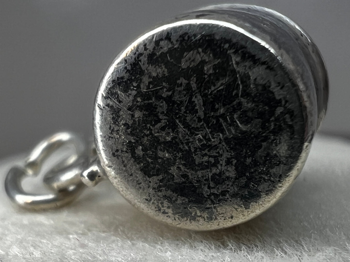 Crafted with charming detail, this vintage sterling silver charm is designed as a baby cup. Perfect for a new parent or anyone who enjoys a reminder of their favorite little one.