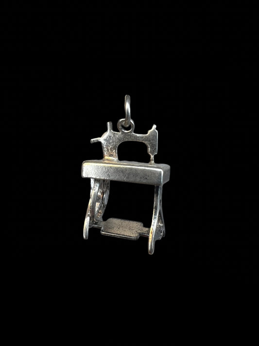 This sterling silver charm is a perfect fit for an artist whose creations involve sewing. Crafted with intricate detail, this miniature sewing machine features a movable wheel.