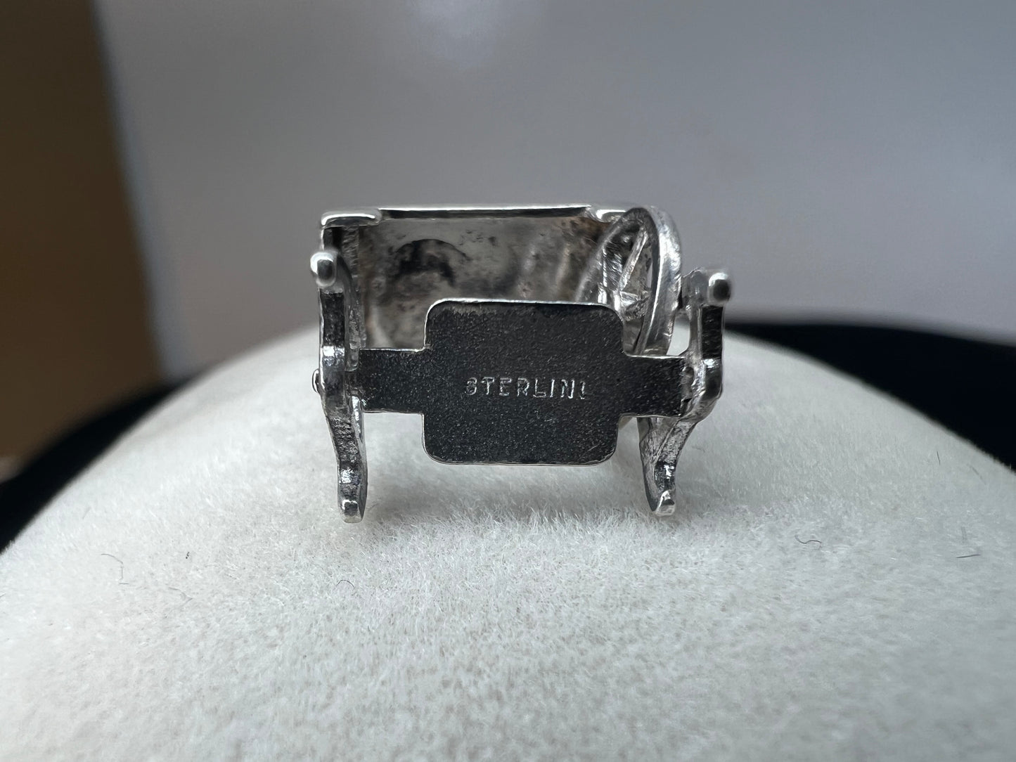 This sterling silver charm is a perfect fit for an artist whose creations involve sewing. Crafted with intricate detail, this miniature sewing machine features a movable wheel.