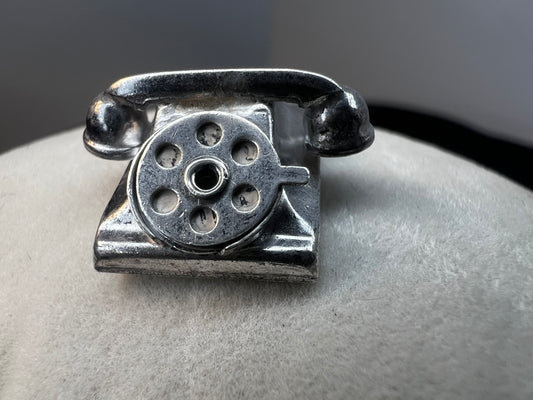 Indulge in nostalgia with our vintage sterling silver charm inspired by the iconic telephone of the past. This would make a charming addition to any collection.