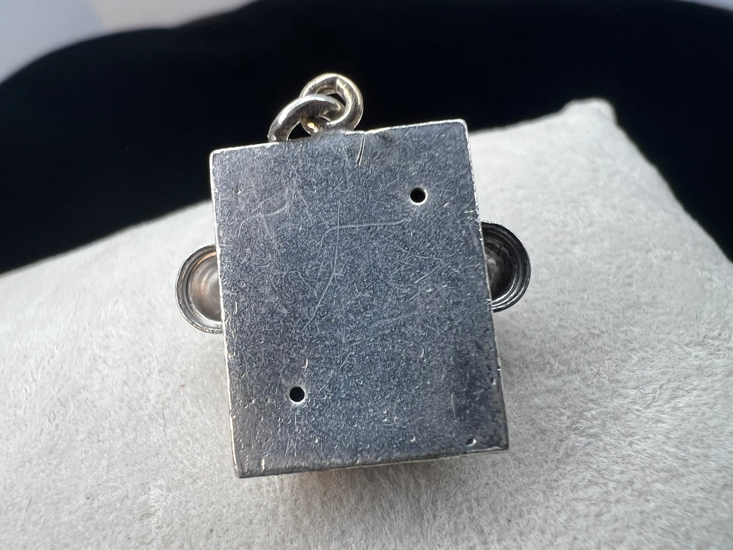 Indulge in nostalgia with our vintage sterling silver charm inspired by the iconic telephone of the past. This would make a charming addition to any collection.