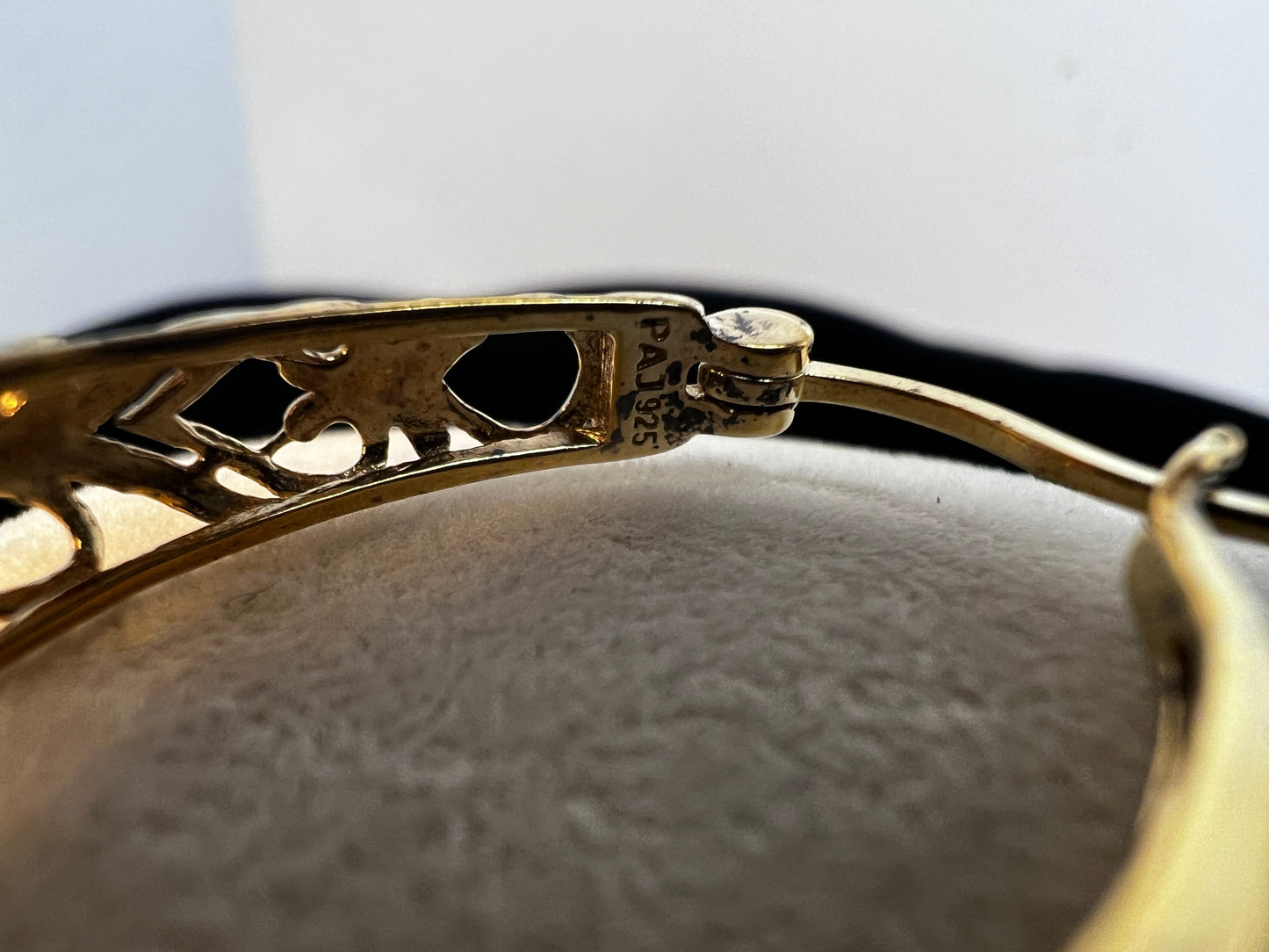 These beautiful filigree-design earrings are crafted of sterling silver with a gold overlay. The oval hoop design will add a touch of class to any outfit.