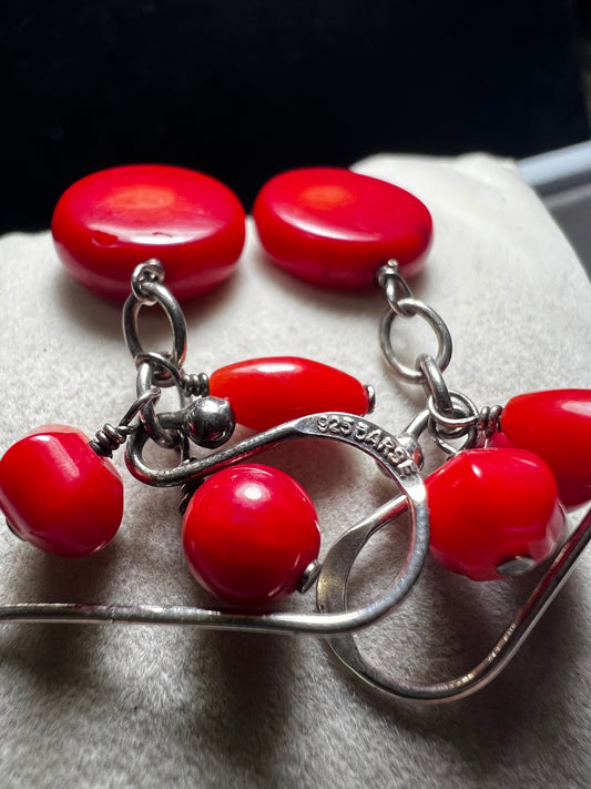 These Barse Jewelry earrings feature vibrant red coral set in sterling silver, combining natural beauty with expert craftsmanship. Their striking color and refined design make them a good choice for adding a bold yet elegant touch to any outfit.