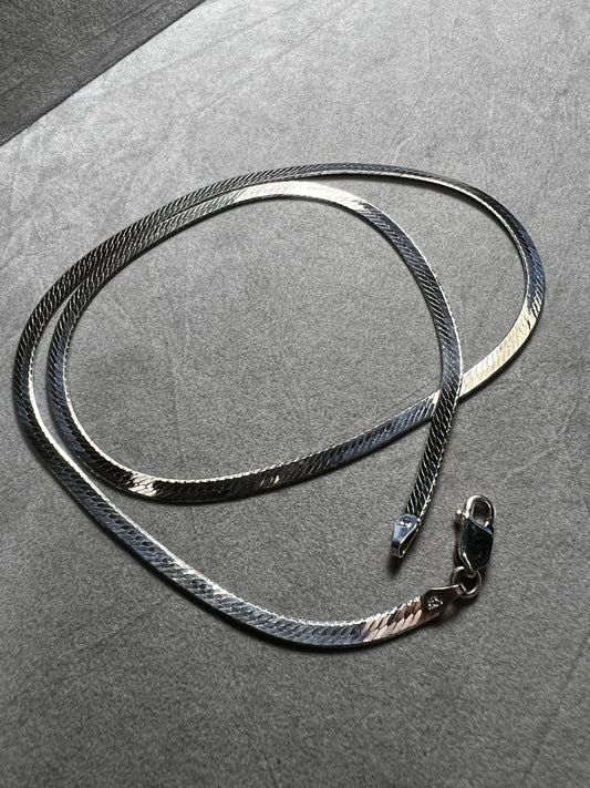 This classic sterling silver herringbone necklace will add just the right touch of shine to your outfit.