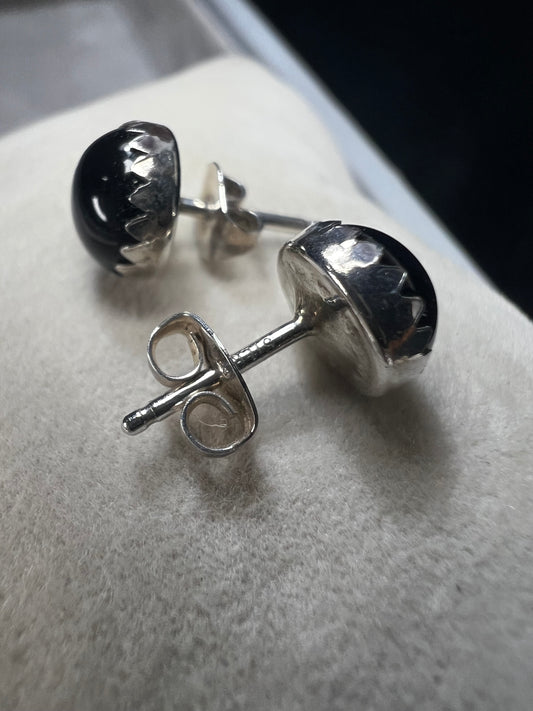 These sterling silver stud earrings feature sleek jet stones, offering a refined and timeless accessory. Their modest size ensures subtle elegance, perfect for adding a sophisticated touch to any outfit without overpowering your look.