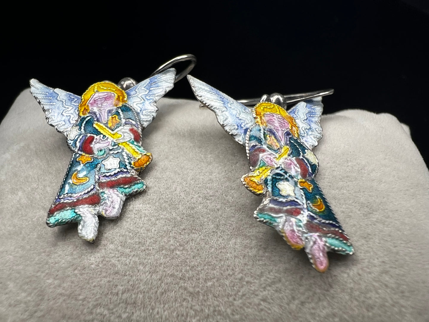 These sterling silver enameled angel earrings combine expert craftsmanship with delicate design. Perfect for those seeking a meaningful accessory, these earrings offer both elegance and a subtle symbol of protection and grace.