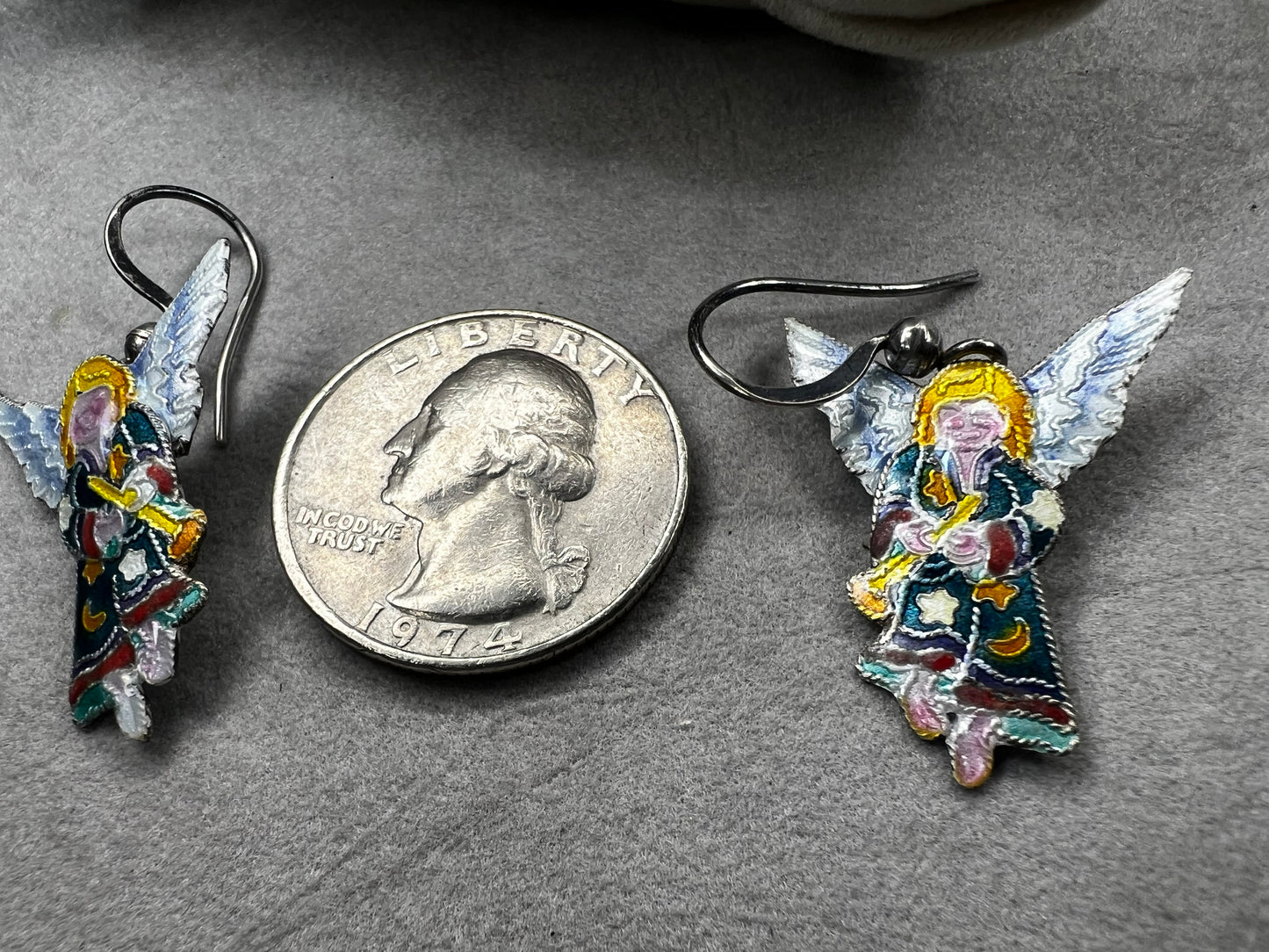 These sterling silver enameled angel earrings combine expert craftsmanship with delicate design. Perfect for those seeking a meaningful accessory, these earrings offer both elegance and a subtle symbol of protection and grace.