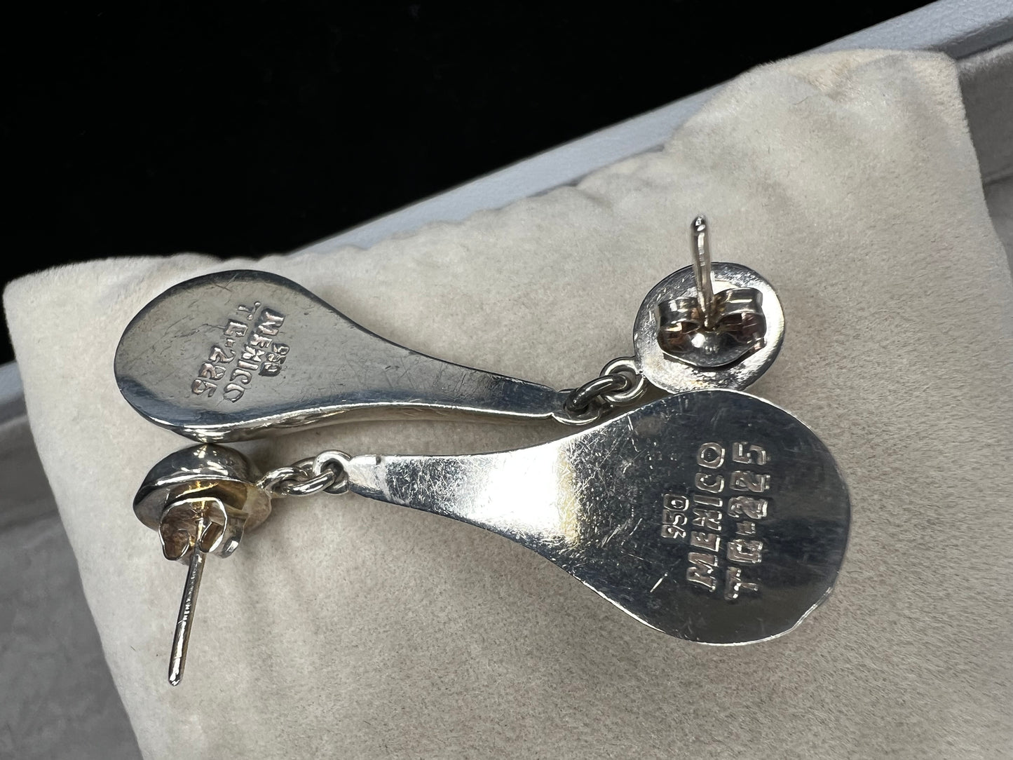 These vintage earrings showcase authentic Taxco craftsmanship, featuring sterling silver with distinctive hallmarks. Designed with elegant ball studs and graceful teardrop shapes, they offer a timeless accessory that reflects expert artistry and quality.
