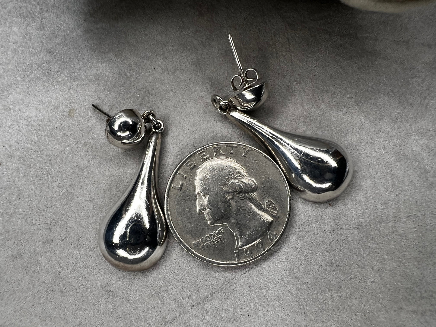 These vintage earrings showcase authentic Taxco craftsmanship, featuring sterling silver with distinctive hallmarks. Designed with elegant ball studs and graceful teardrop shapes, they offer a timeless accessory that reflects expert artistry and quality.