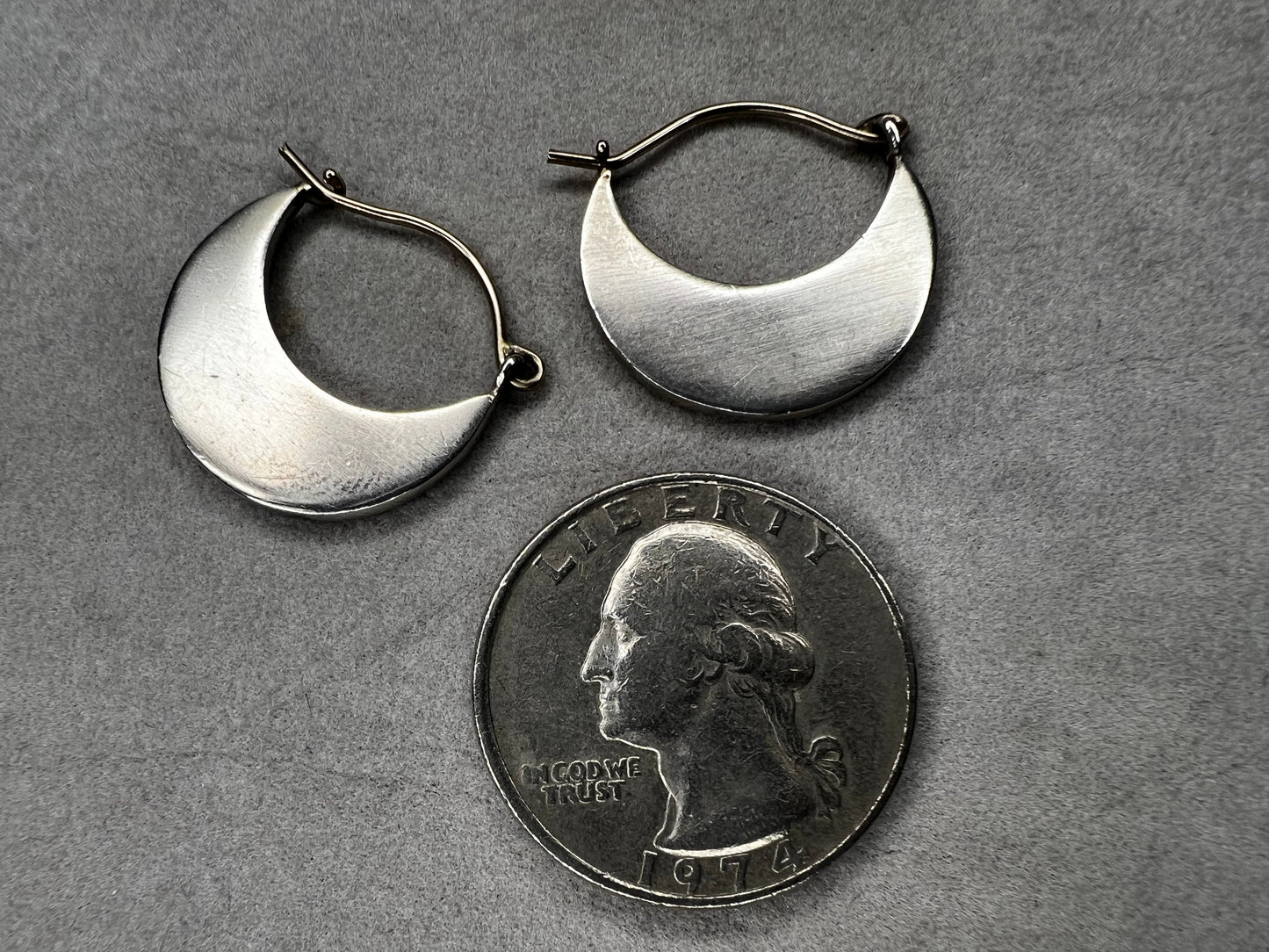 These sterling silver half moon earrings feature a brushed finish on the bottom half, paired with gold overlays on the top hooks. Combining silver and gold tones, they offer a modern, versatile style that complements everyday wear while adding an elegant touch.
