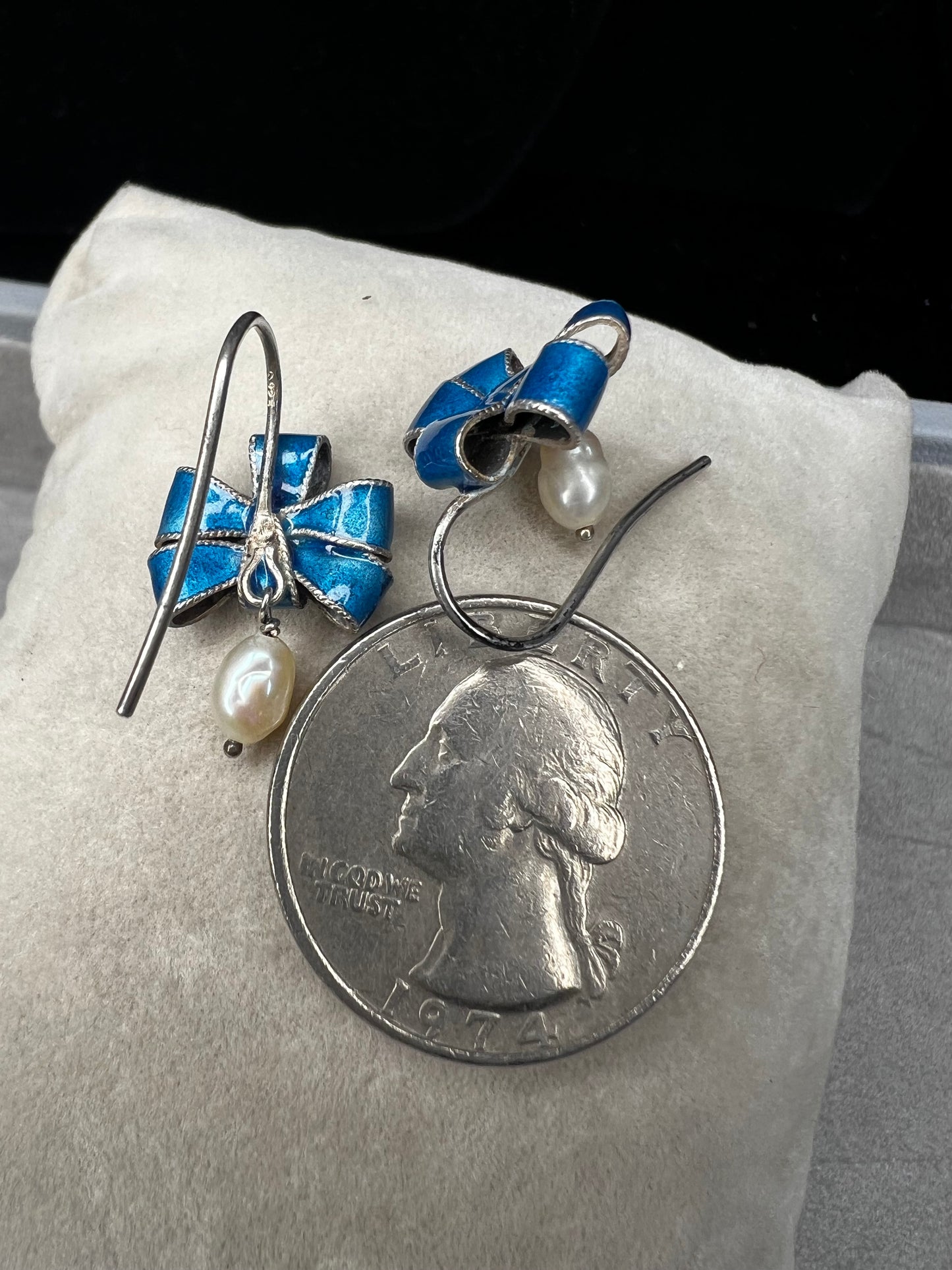 Blue and silver earrings with pearls on a quarter for scale