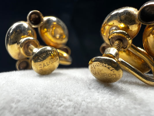 These Bal Ron gold-filled earrings feature three natural stone scarabs on each piece. Designed as screw-back earrings, they offer a unique, comfortable option for those without pierced ears. The combination of natural stones adds a subtle yet distinctive mix of colors, making these earrings an ideal choice for anyone seeking both elegance and individuality.