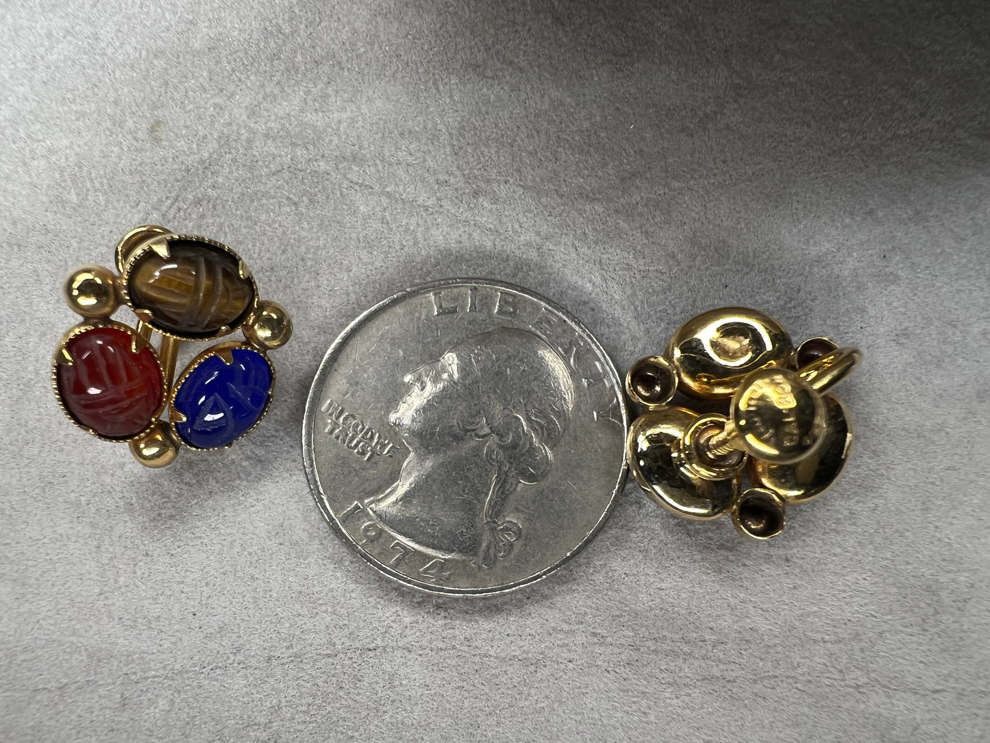 These Bal Ron gold-filled earrings feature three natural stone scarabs on each piece. Designed as screw-back earrings, they offer a unique, comfortable option for those without pierced ears. The combination of natural stones adds a subtle yet distinctive mix of colors, making these earrings an ideal choice for anyone seeking both elegance and individuality.