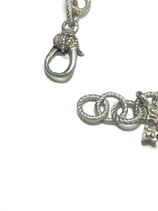 Elevate your style with this Ann King sterling silver charm bracelet. It features five detailed silver crosses, three of which are accented with luxurious 18k gold. This piece is perfect for adding a touch of faith and elegance to any outfit.