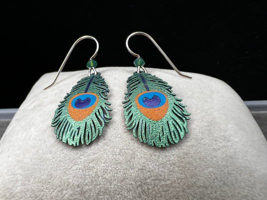 These sterling silver earrings showcase a unique design inspired by peacock feathers, enhanced with vibrant enamel detailing.