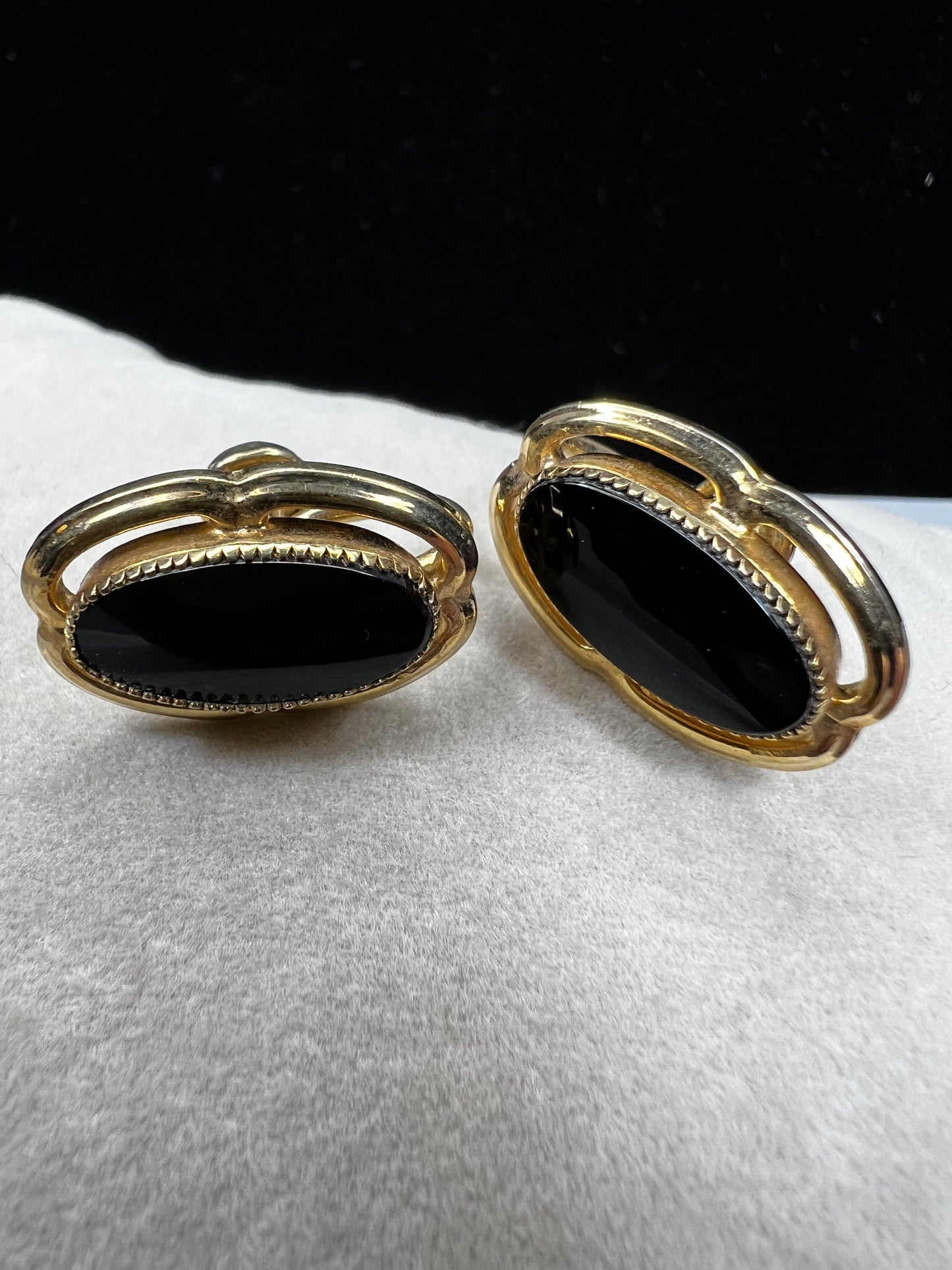 These screw-back earrings feature a beautiful oval piece of jet set in a stylish gold-filled frame.