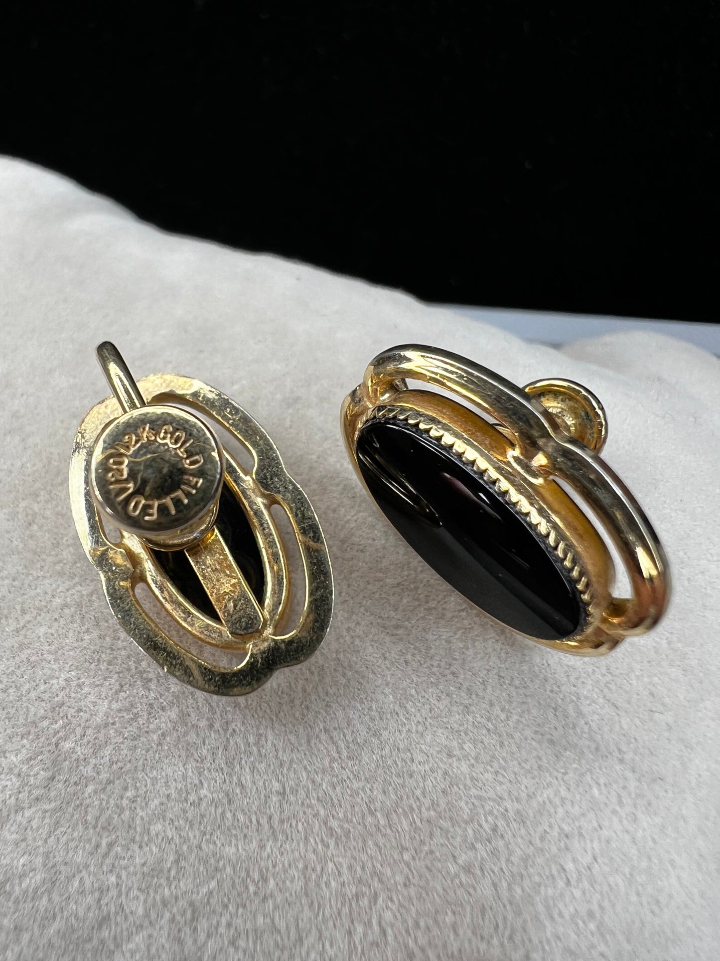 These screw-back earrings feature a beautiful oval piece of jet set in a stylish gold-filled frame.
