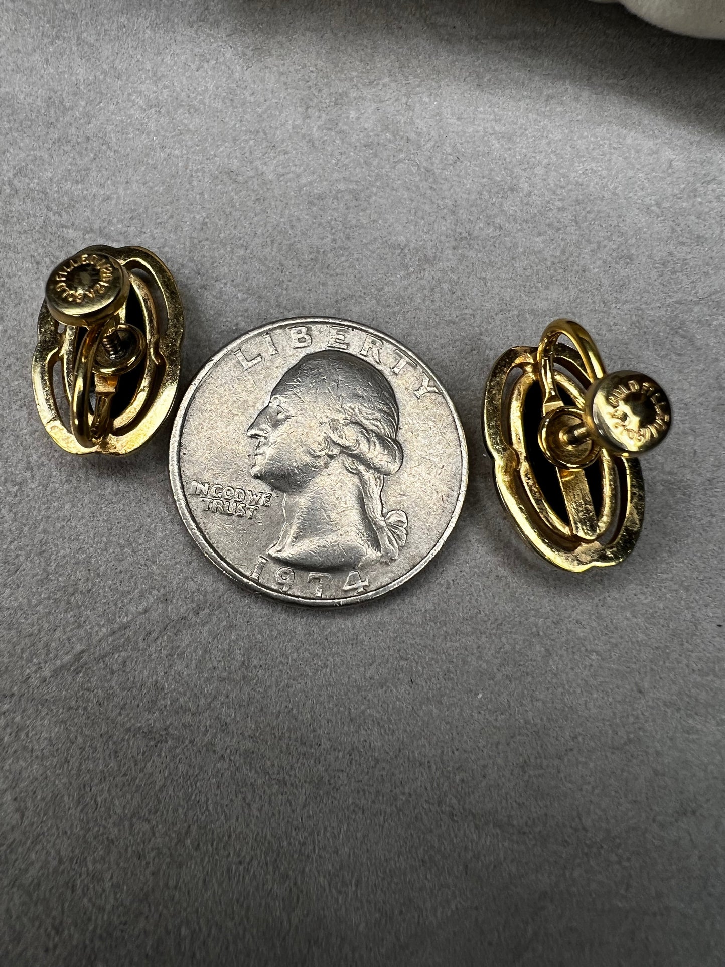 These screw-back earrings feature a beautiful oval piece of jet set in a stylish gold-filled frame.
